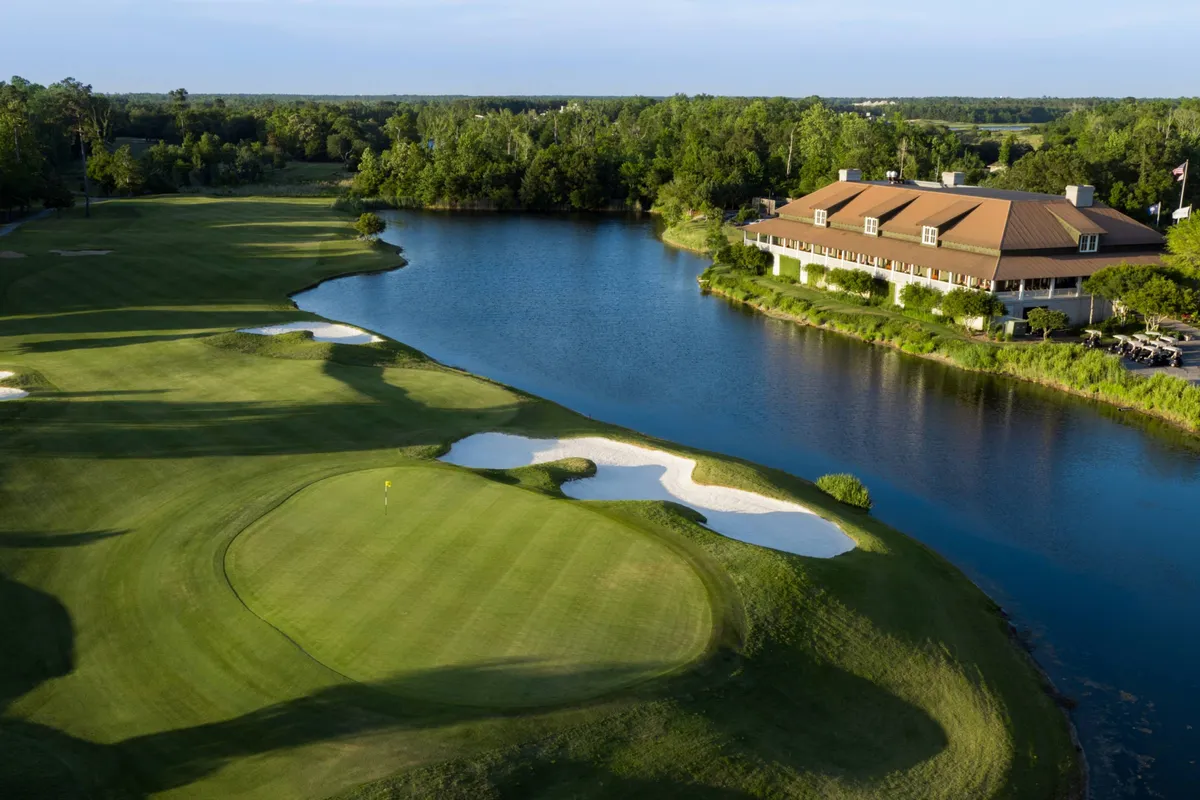 This exterior image captures the lush green golf course, a stately clubhouse, and a serene lake, all bathed in soft natural light. The scene conveys a sense of relaxation and recreation, directly referencing the golf experiences available nearby.